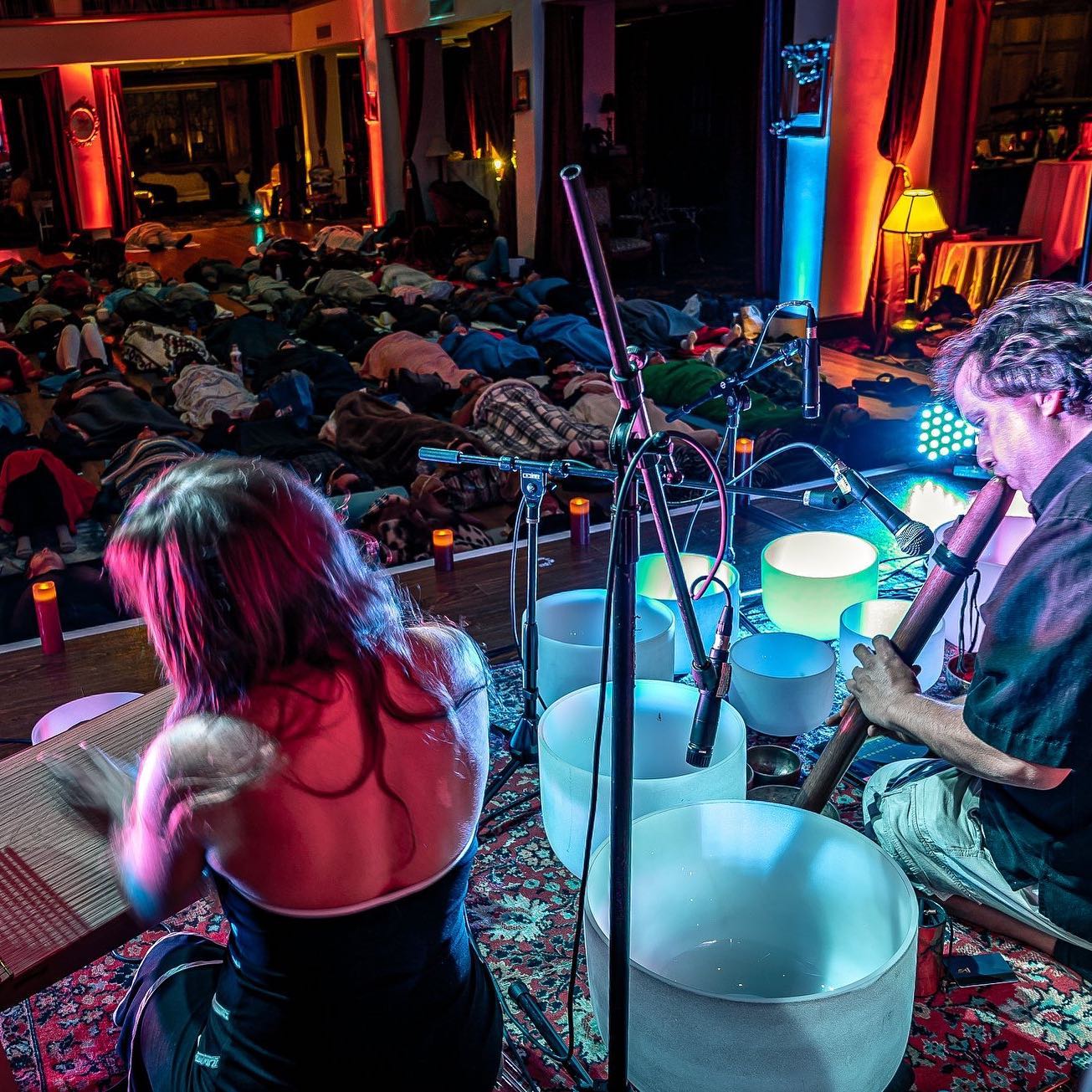Guy and Simona leading a sound bath with crystal singing bowls